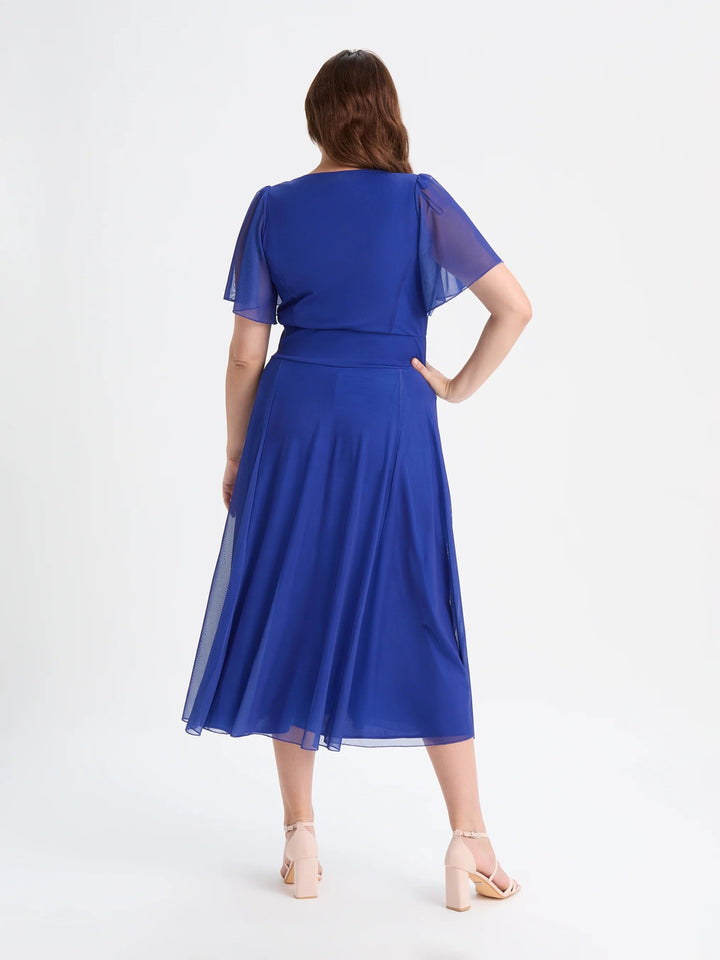 Woman wearing blue Scarlett and Jo Liz midi dress, plus size wedding guest outfit back view Belfast